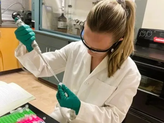 Picture of Paige using a pipette to fill a vial