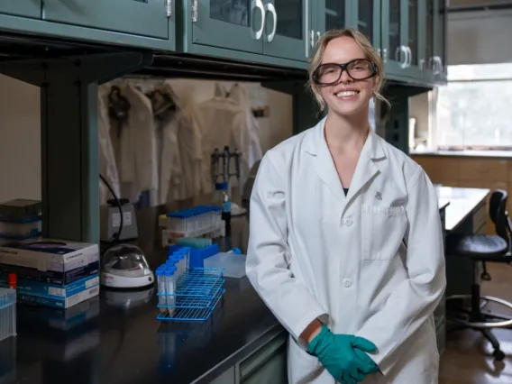 Picture of Paige Wagstaff standing in front of a laboratory bench