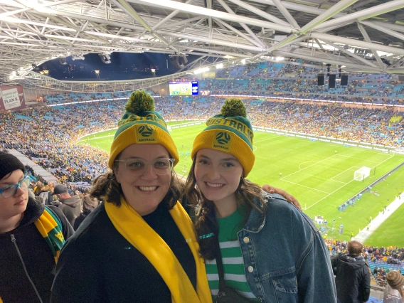 Elissa Schiff poses with a friend at a soccer game in Australia