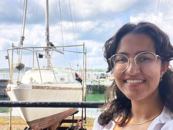 Arpita standing in front of a ship in dry dock in Cobh