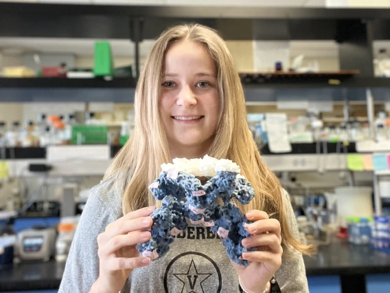 Picture of Natalie Rawlings in front of a lab bench