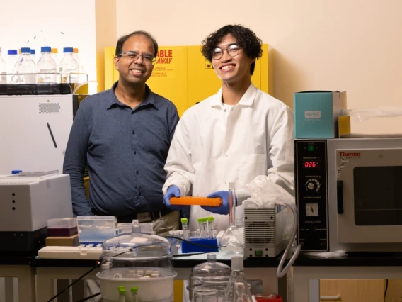 Picture of Abhijit Date and Tom Pham standing at the lab bench