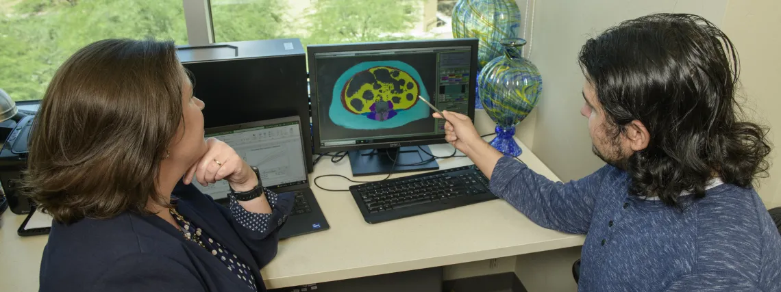 Picture of NACP student Ferris Saad and Dr. Jennifer Bea observing an MRI image at Abrams Public Health Center