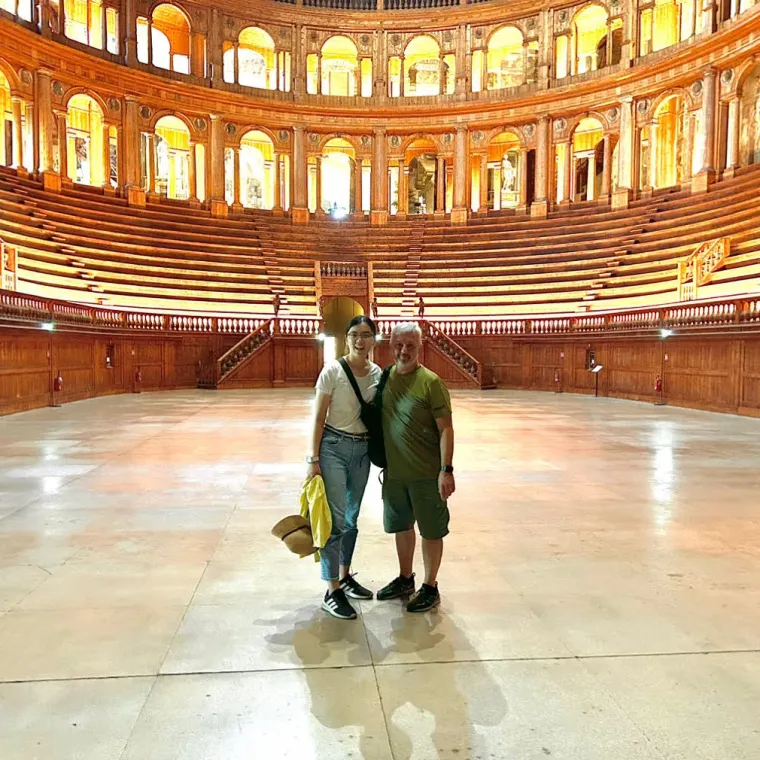 Picture of Sun and Dr. Ferrari surrounded by the classic arched walls of Teatro Farnese