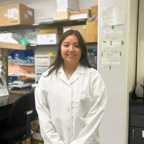 Picture of Leila standing in front of her lab bench