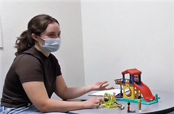 Picture of Elissa Schiff sitting at a table with toys