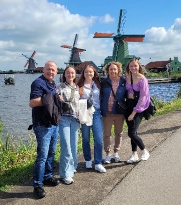 Picture of Erin with a group of friends in front of windmills