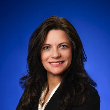 Headshot of Dr. Cynthia Carr with a blue background