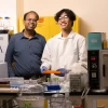 Picture of Abhijit Date and Tom Pham standing at the lab bench