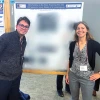 Gamaliel Isai Luna and Martha Bhattacharya standing next to scientific poster